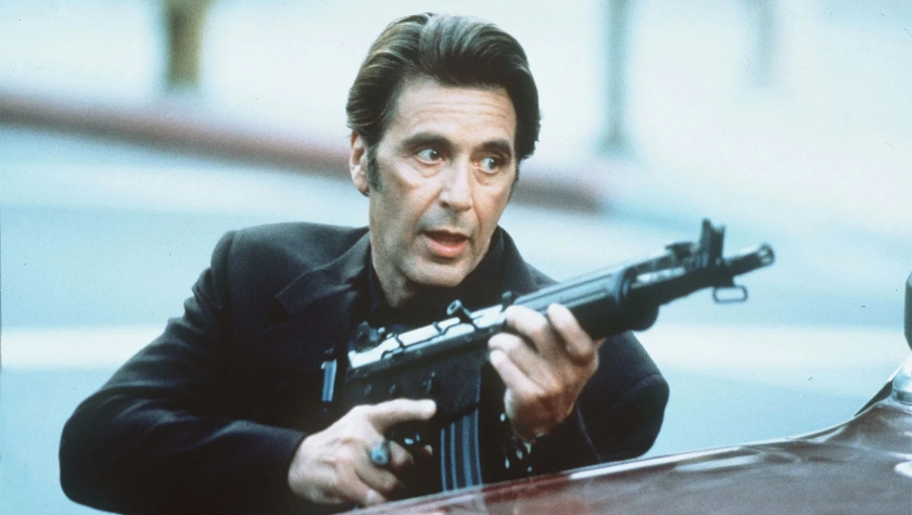 Vincent Hanna (Al Pacino) aiming a rifle during the climactic street shootout in Heat