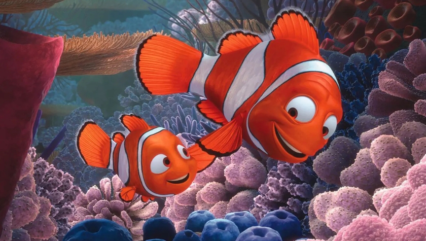 Marlin and Nemo swim together among the coral reef in a still from Finding Nemo (2003)