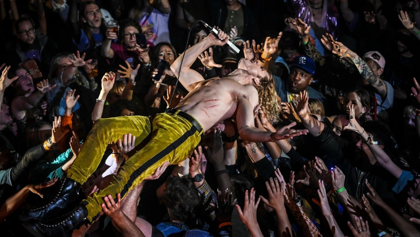 Sam Reid as Lestat crowd-surfing on stage, shirtless with scratch marks across his chest