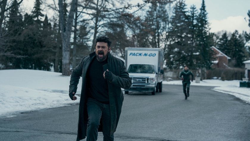 Billy Butcher running through a snowy street